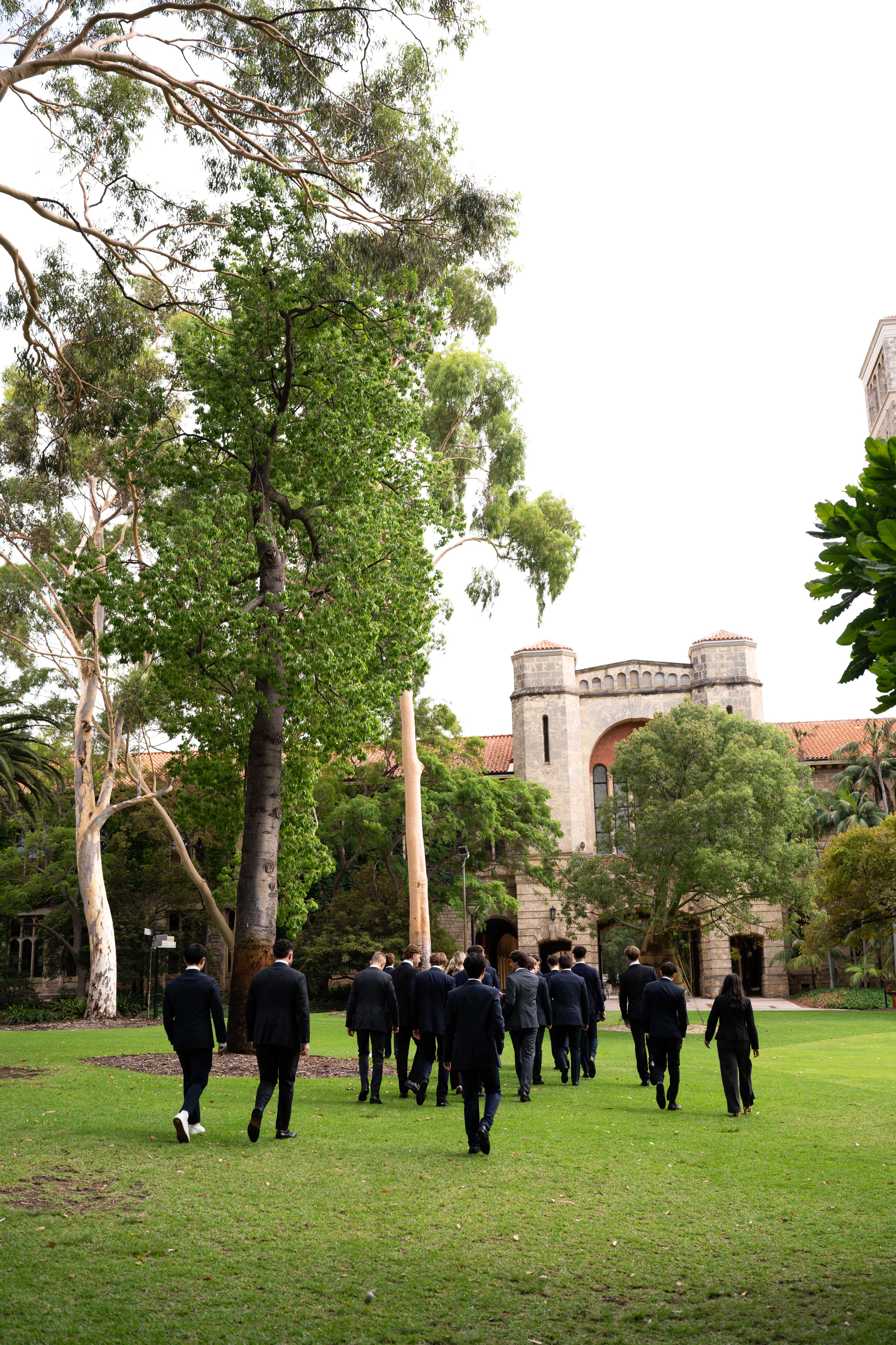 UWA Student Managed Investment Fund members walking toward Winthrop Hall through the campus gardens